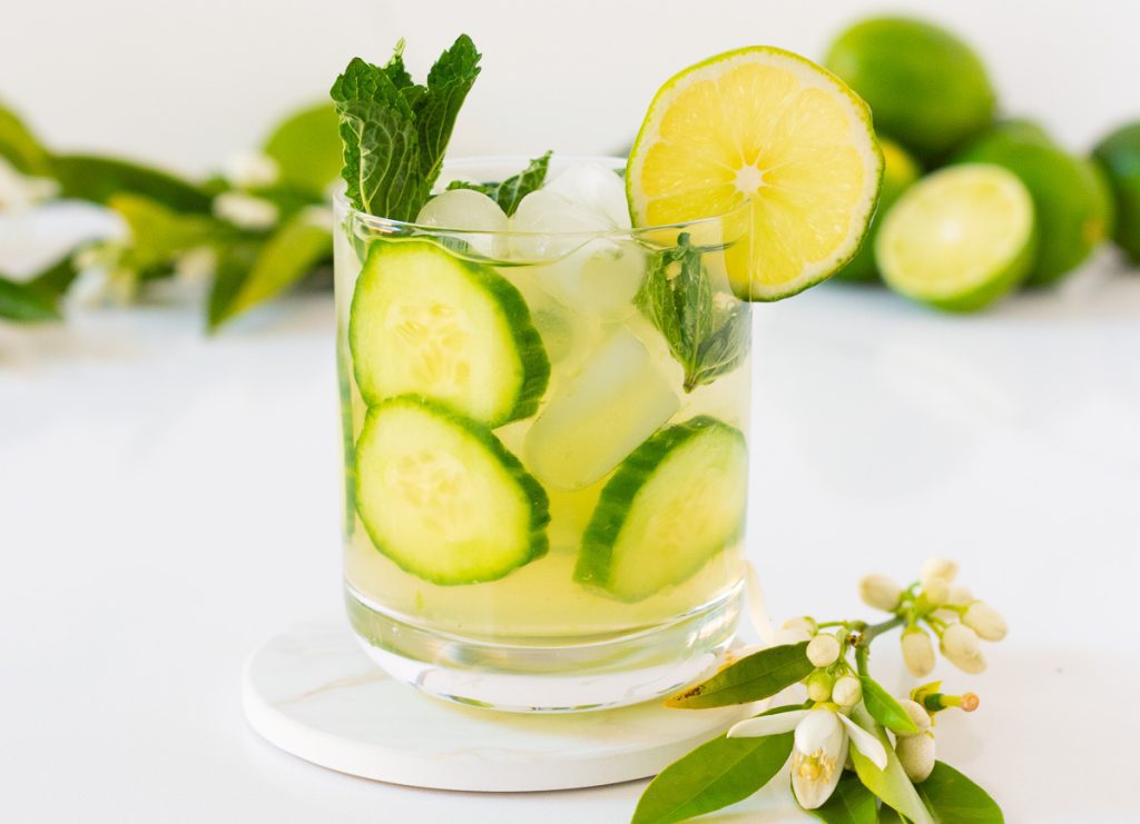 Glass of cucumber mojito mocktail with mint and cucumber slices 