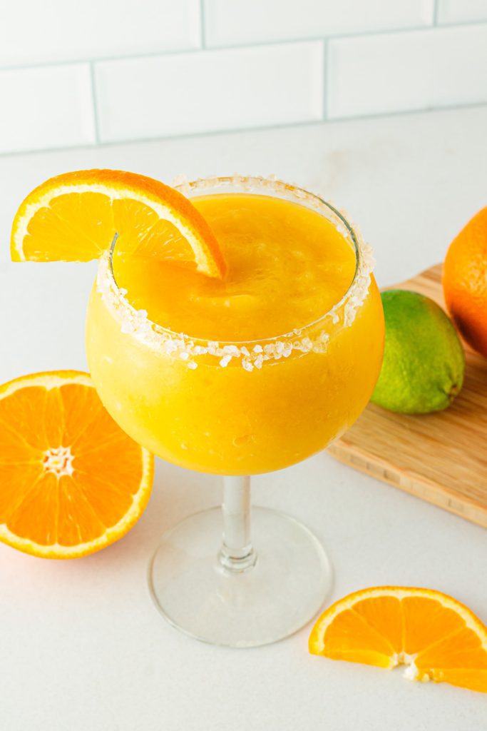 Glass of frozen mango margarita mocktail with salted rim