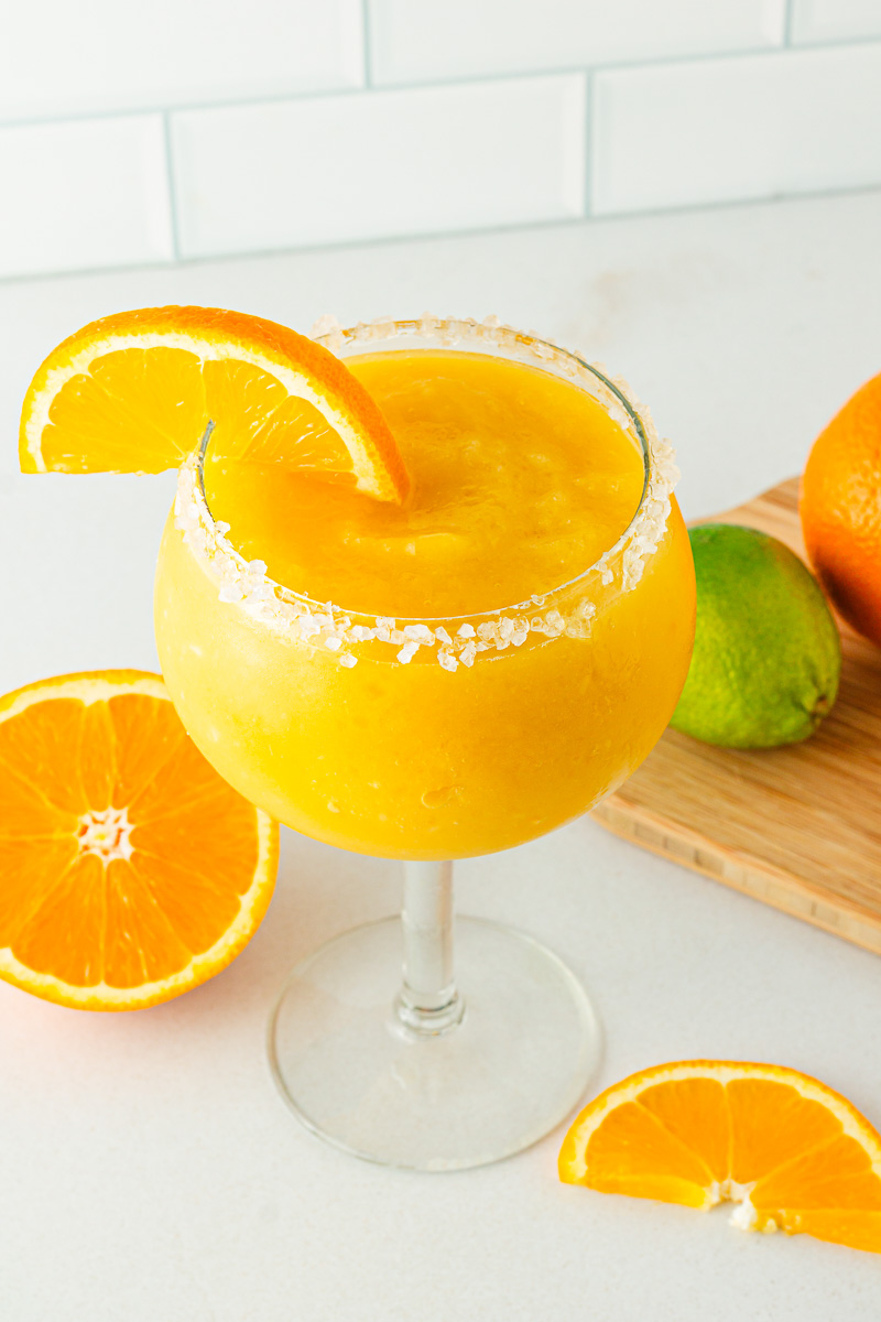 Glass of frozen mango margarita mocktail with salted rim