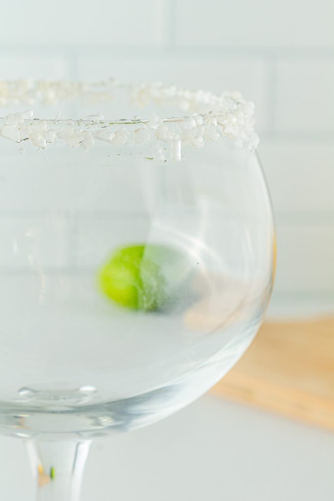 Dipping margarita glass in salt for frozen mocktail