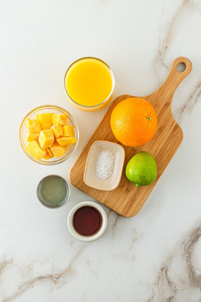 Ingredients for virgin mango margarita mocktail on counter