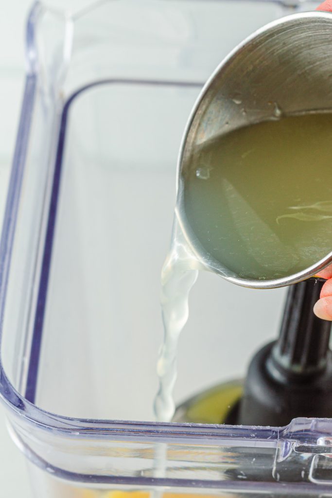 Adding liquids to blender for mocktail