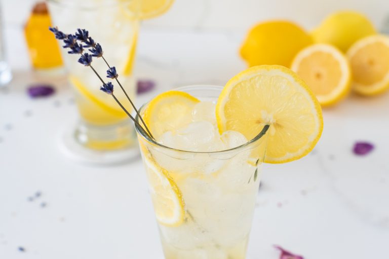 Lavender Lemonade with lemon slices and a sprig of lavender Dry January Mocktail