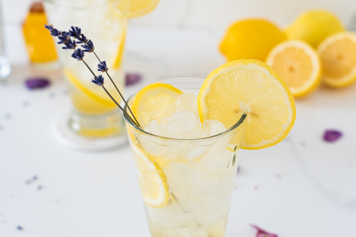 Lavender Lemonade with lemon slices and a sprig of lavender Dry January Mocktail