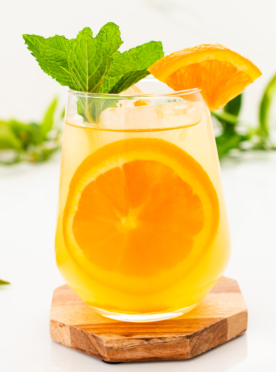 Glass of orange mocktail with a slice of orange