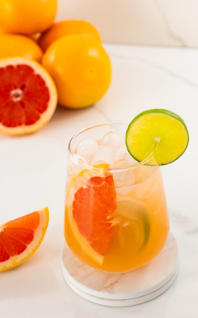 Grapefruit and Lime Mocktail in tall glass with ice and slices of fruit