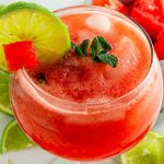 Watermelon mocktail in a large glass with lime slice