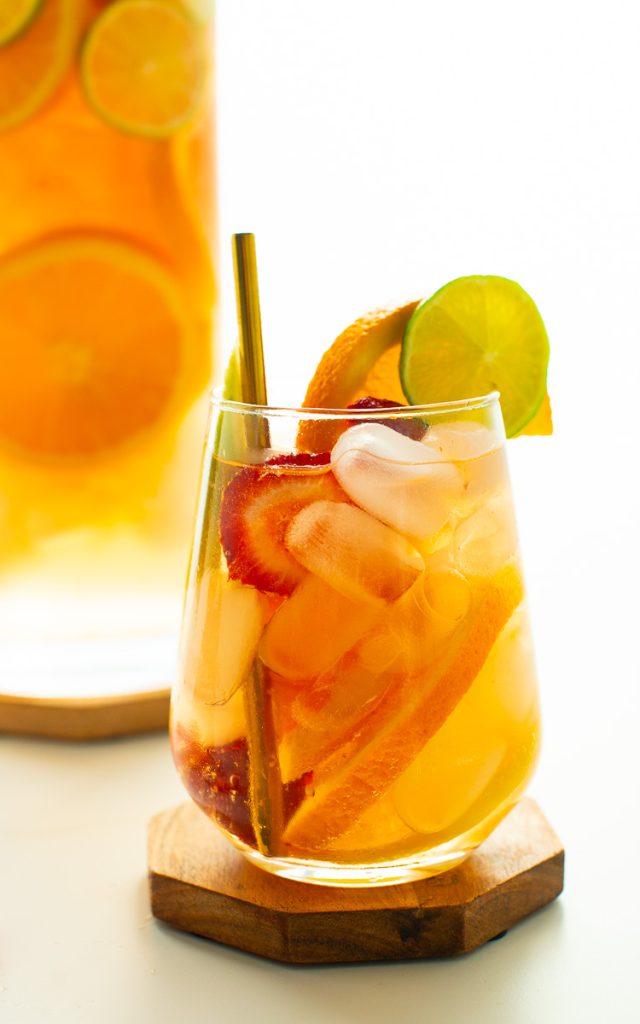 Sangria mocktail in elegant glass with sliced fresh fruit
