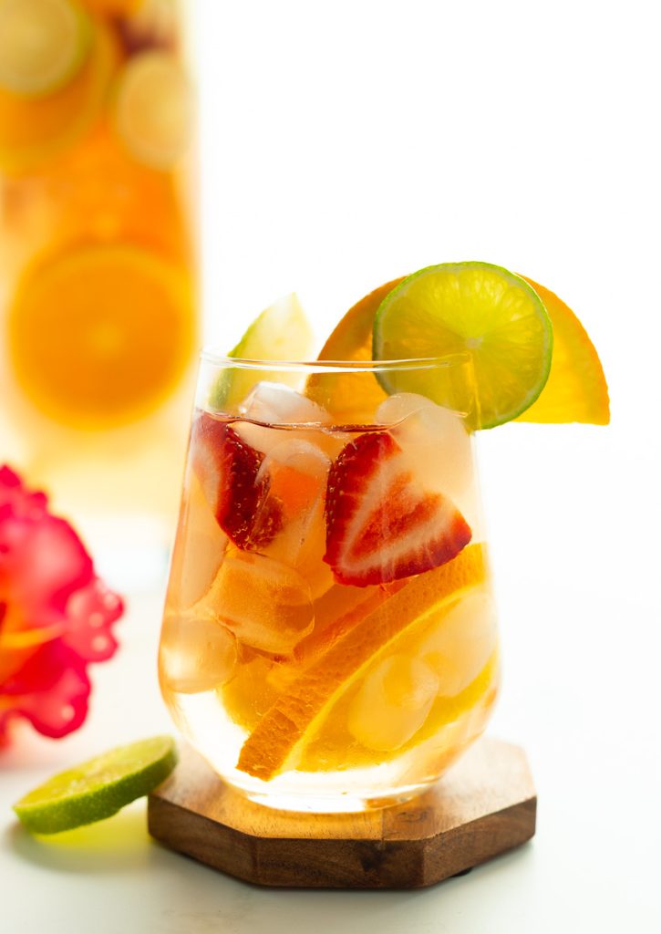 glass of non-alcoholic sangria with slices of fresh citrus and strawberries