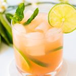 Glass of guava mocktail with lime wedge
