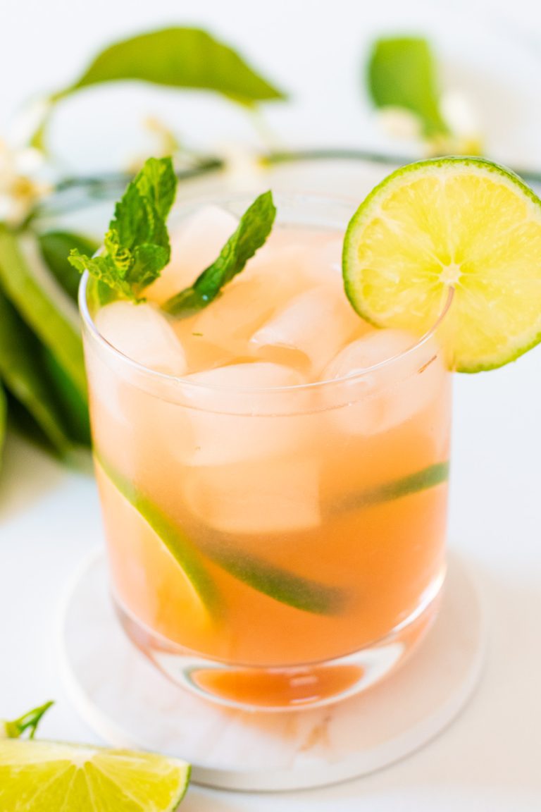 Glass of guava mocktail with lime wedge