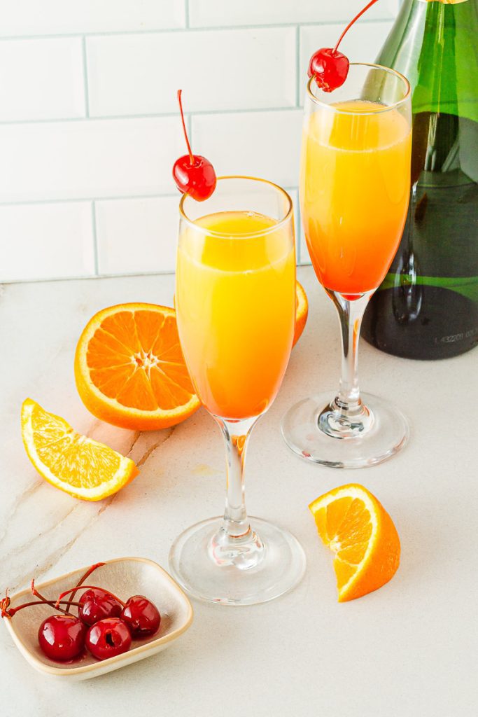 “Easy Sunrise Mocktail with orange juice and grenadine layers in champagne flute.