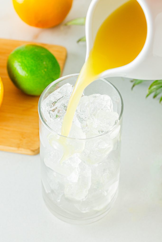 Pour pineapple juice into the glass
