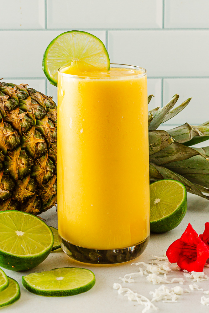 Glass of creamy Mango Mocktail with lime garnish and tropical vibes