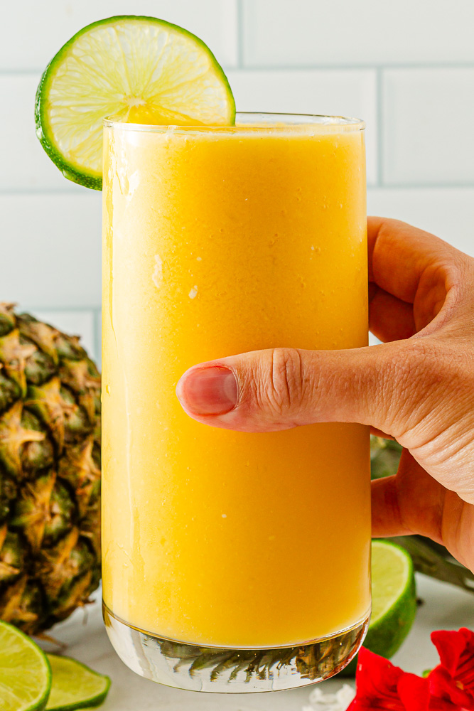 Creamy tropical Mango Mocktail in glass with lime wedge, ready to serve