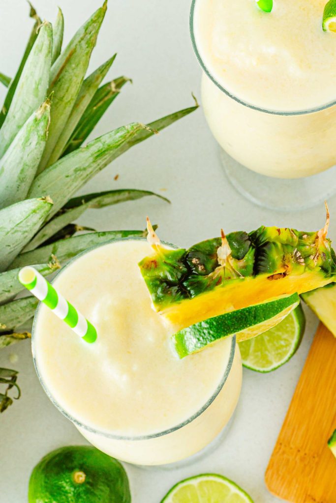 Two non-alcoholic summer drinks with pineapple