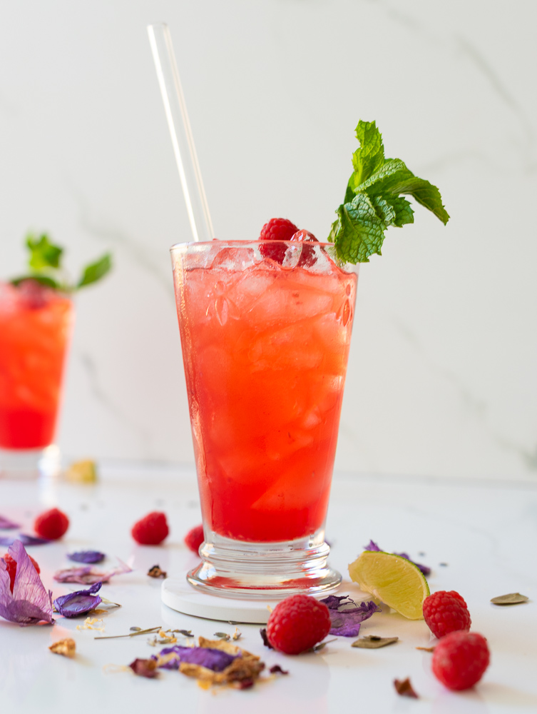 glass of raspberry mojito mocktail with lavender
