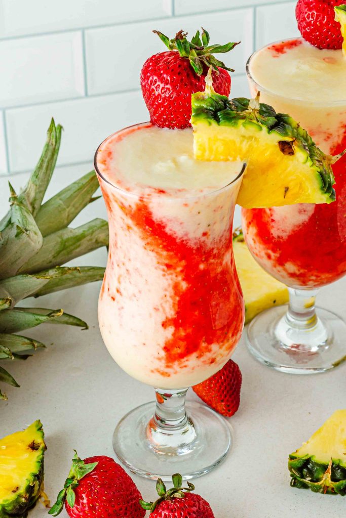 Two glasses of strawberry pina colada lava flow mocktail