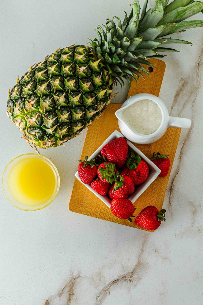 Pineapple, pineapple juice, stgrawberries and coconut milk for Virgin Strawberry Pina Colada