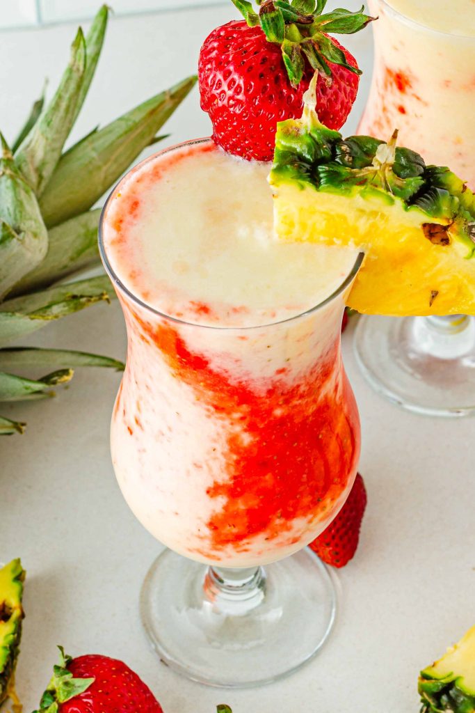 Glass of Virgin Pina Colada in glass with pineapple and strawberries