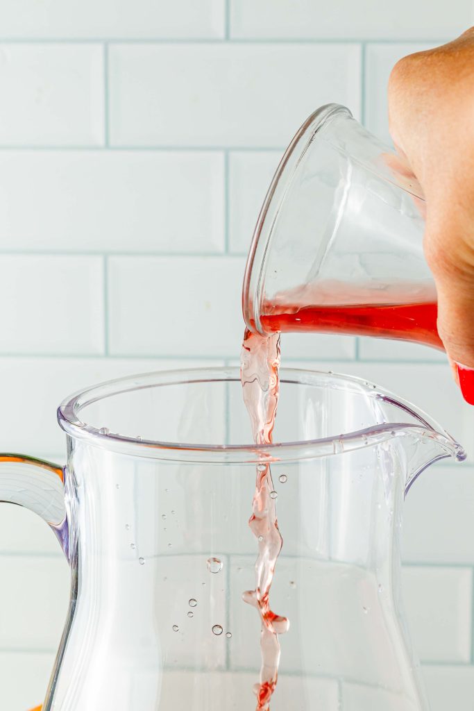 Adding cranberry juice to pitcher