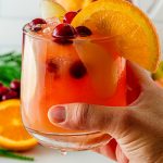 hand holing a glass of non-alcoholic holiday punch