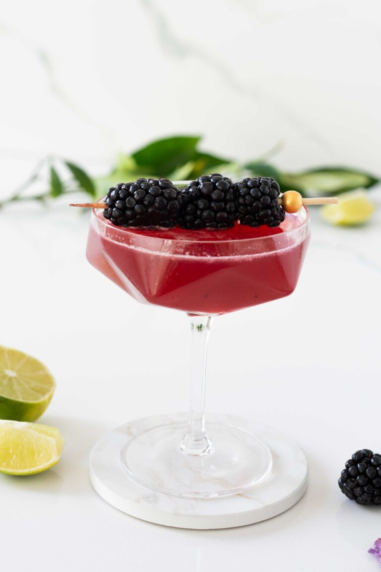 Coupe glass of blackberry mocktail with blackberries