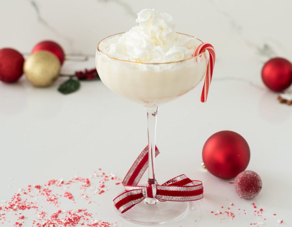 Tall Glass with non-alcoholic christmas drink of white chocolate and peppermint and whipped cream
