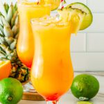 Tropical hurricane mocktail with pineapple juice, passion fruit syrup, citrus, and grenadine sunset layers