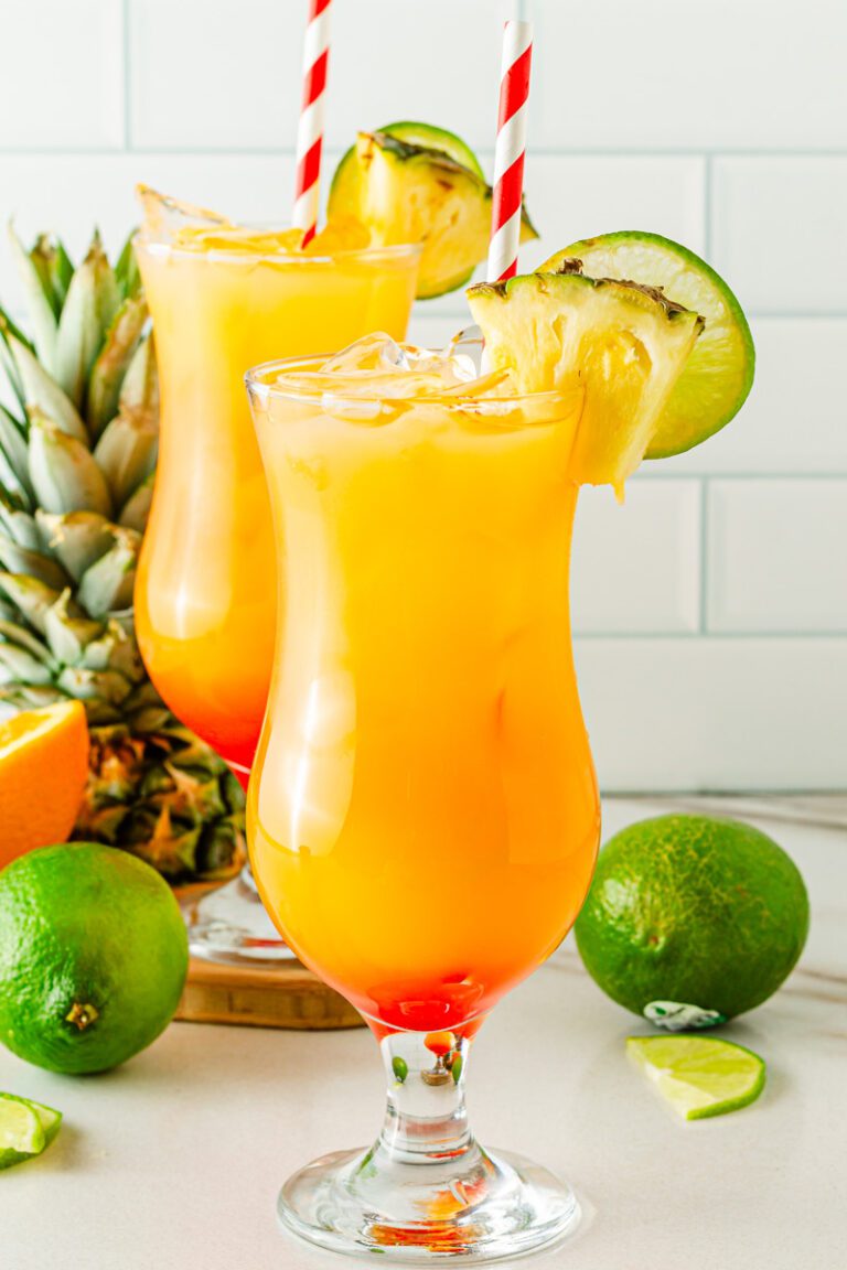 Tropical hurricane mocktail with pineapple juice, passion fruit syrup, citrus, and grenadine sunset layers