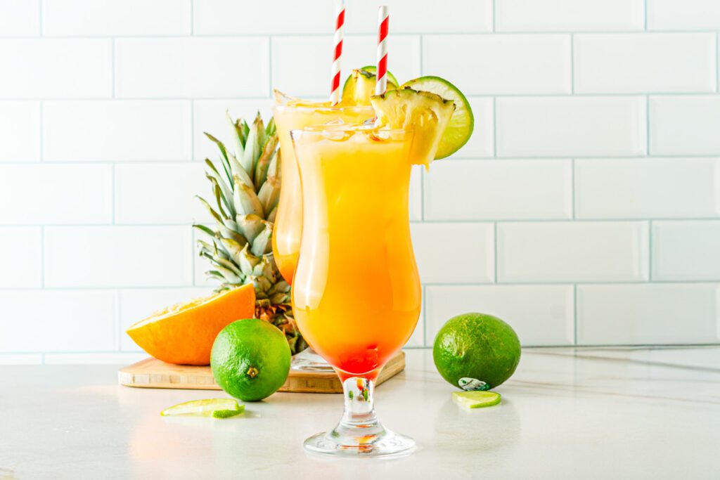 glasses of tropical hurricane mocktail with red and white straws