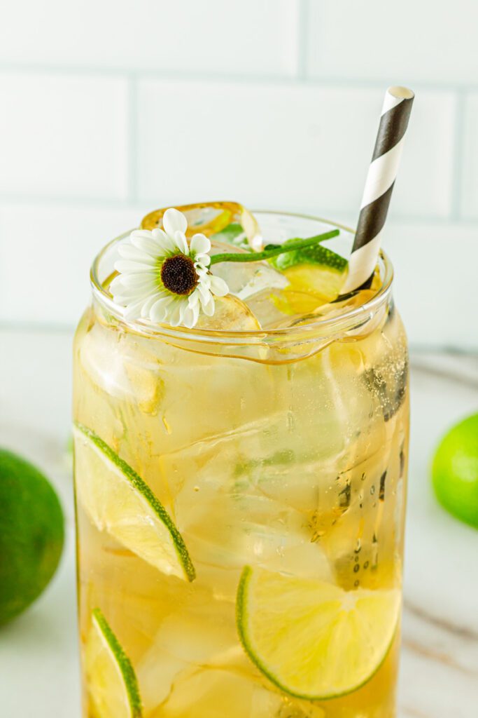 glass of passionflower mocktail with daisy