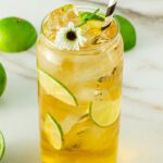 Passionfruit Mocktail in glass with a daisy