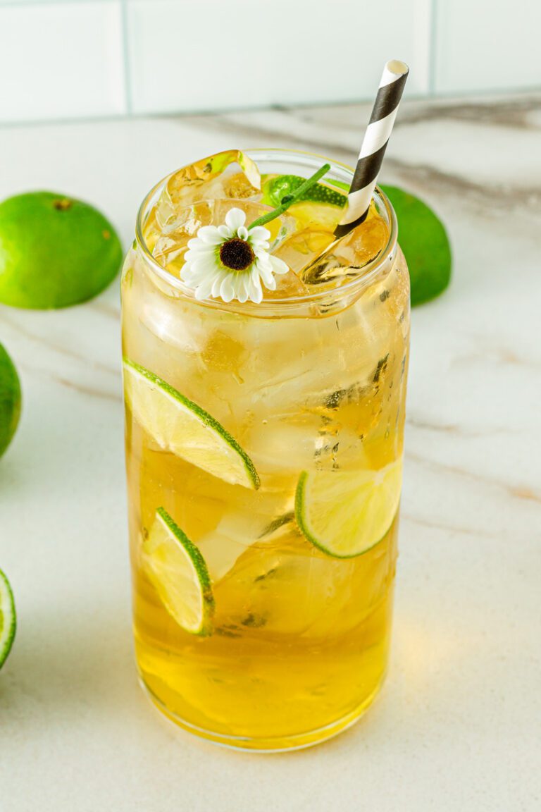 Passionfruit Mocktail in glass with a daisy