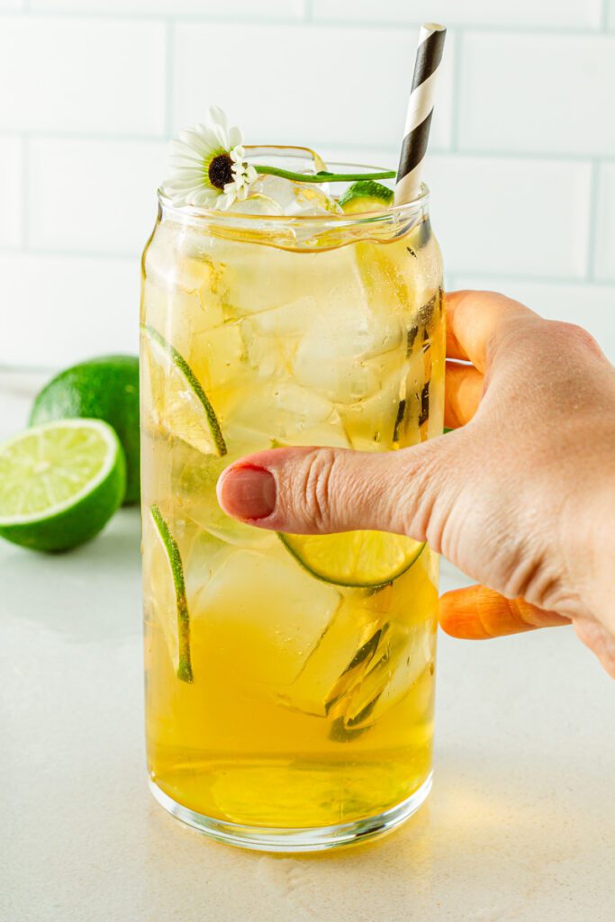 hand holding passionfruit ginger mocktail