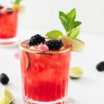 glass of blackberry mojito mocktail with fresh mint and lime