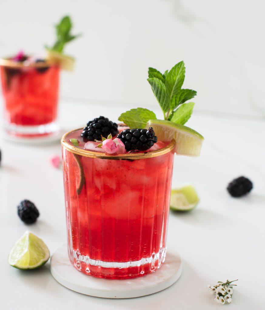 glass of blackberry mojito mocktail with fresh berries, mint and lime