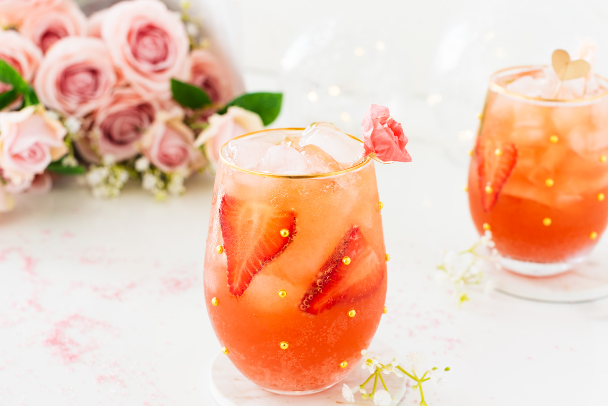 strawberry spritz mocktail with pink rosé, strawberries, and sparkling bubbles