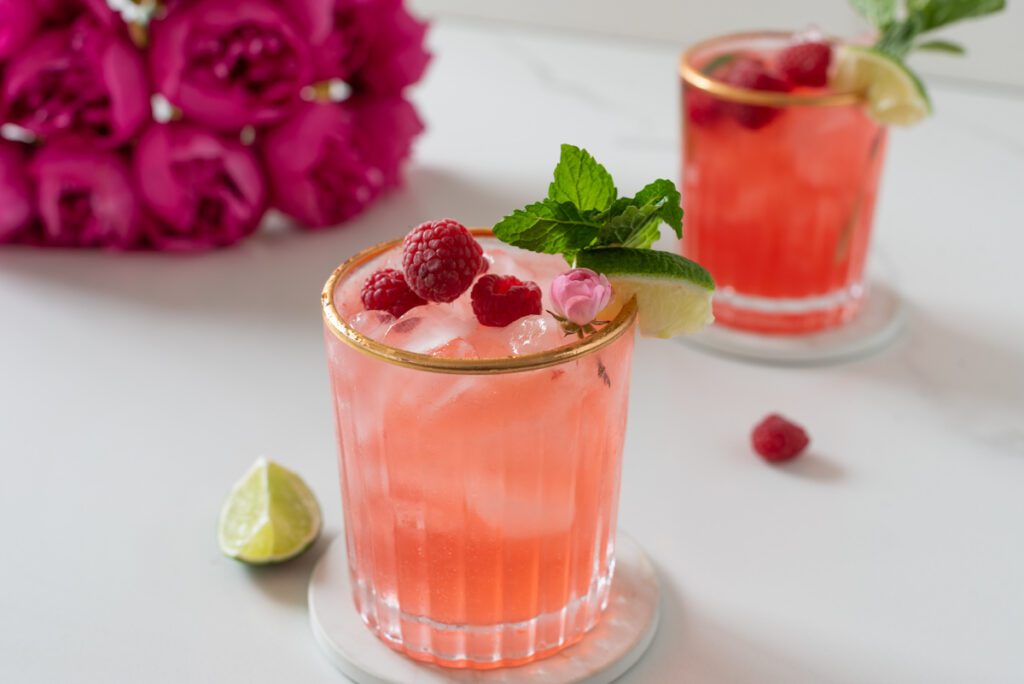 glasses of raspberry mojito mocktail with fresh mint and citrus