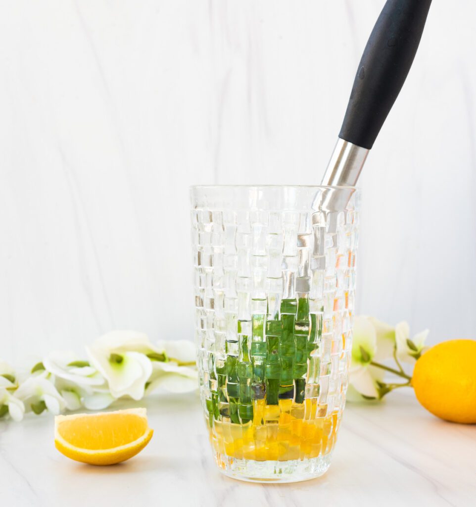 crushing mint in cocktail shaker