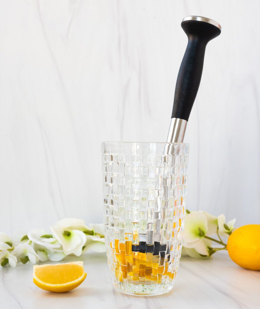 Crushing lemons in cocktail shaker