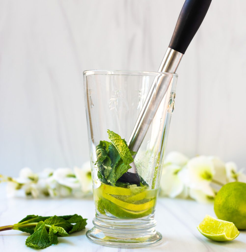 crush mint for coconut mocktail in shaker glass