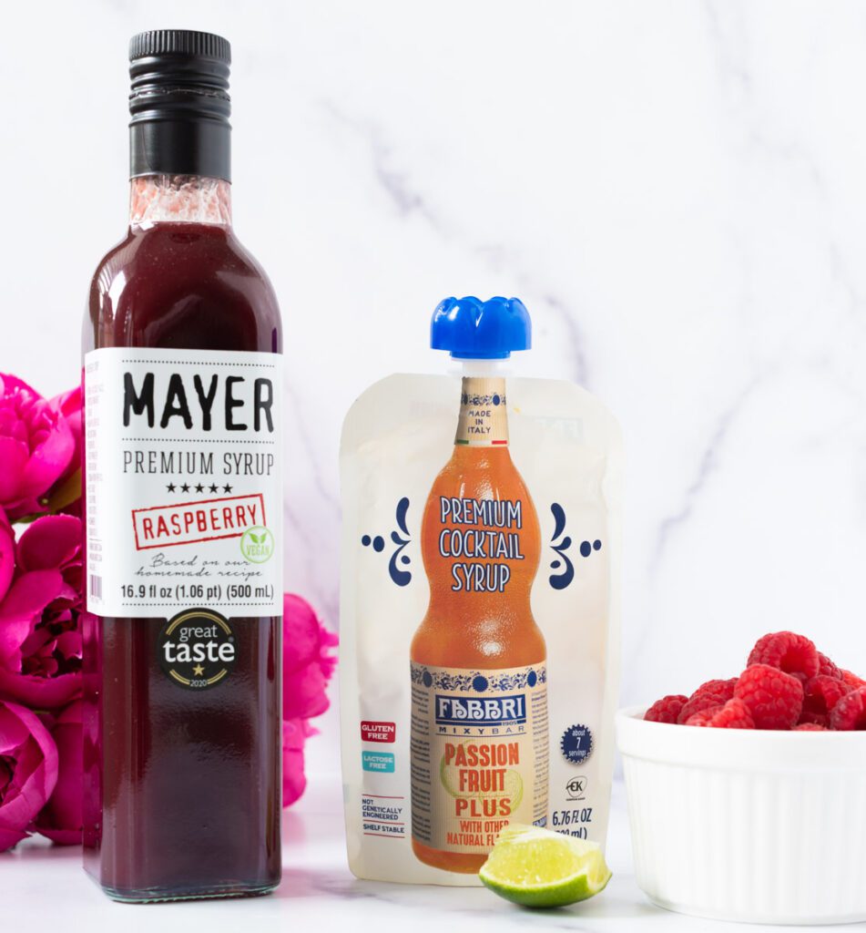 Ingredients for non-alcoholic pink mocktail with raspberries, limes and non-alcoholic sparkling white wine