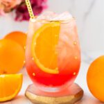oranges and an Aperol spritz mocktail with flowers