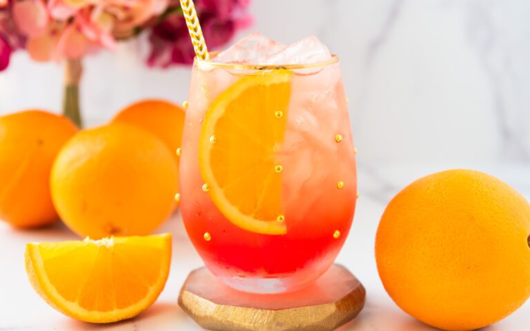 oranges and an Aperol spritz mocktail with flowers
