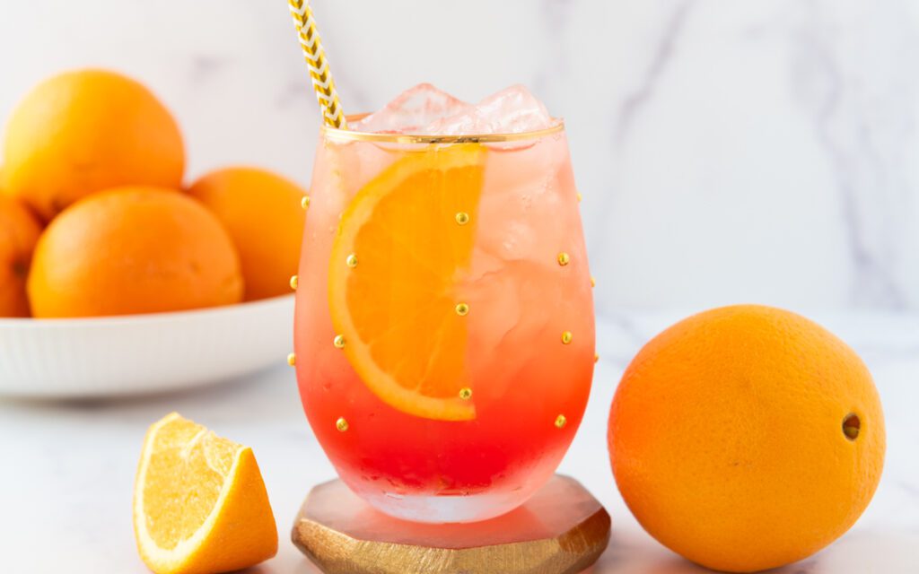 glass of Aperol Spritz Mocktail with fresh oranges