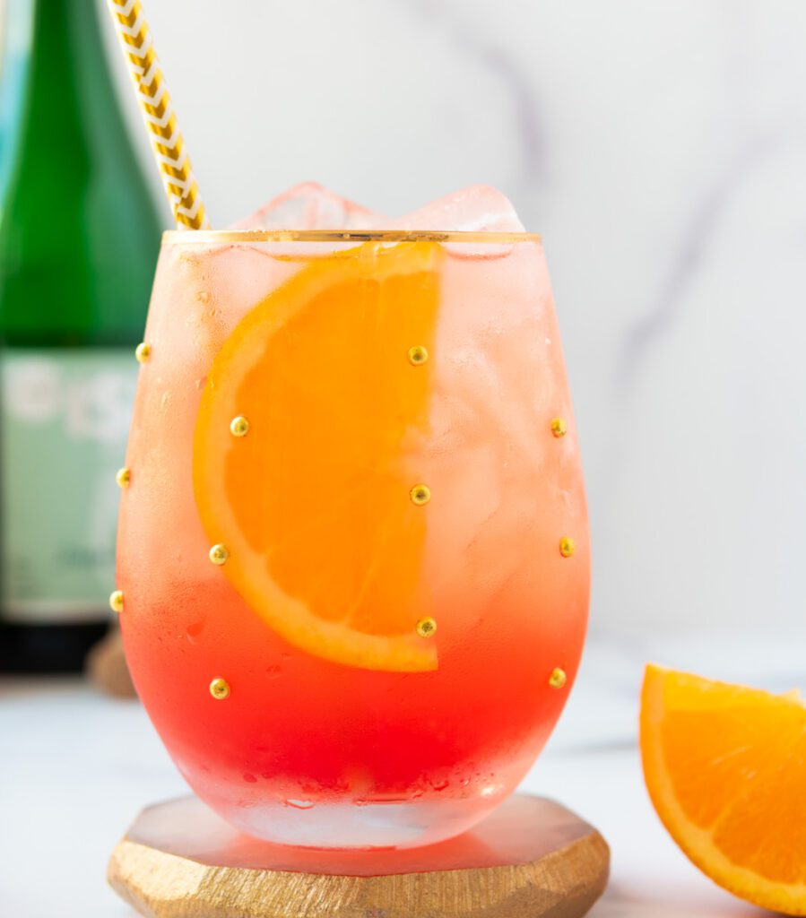 glasses on non-alcoholic Aperol Spritz with bright oranges
