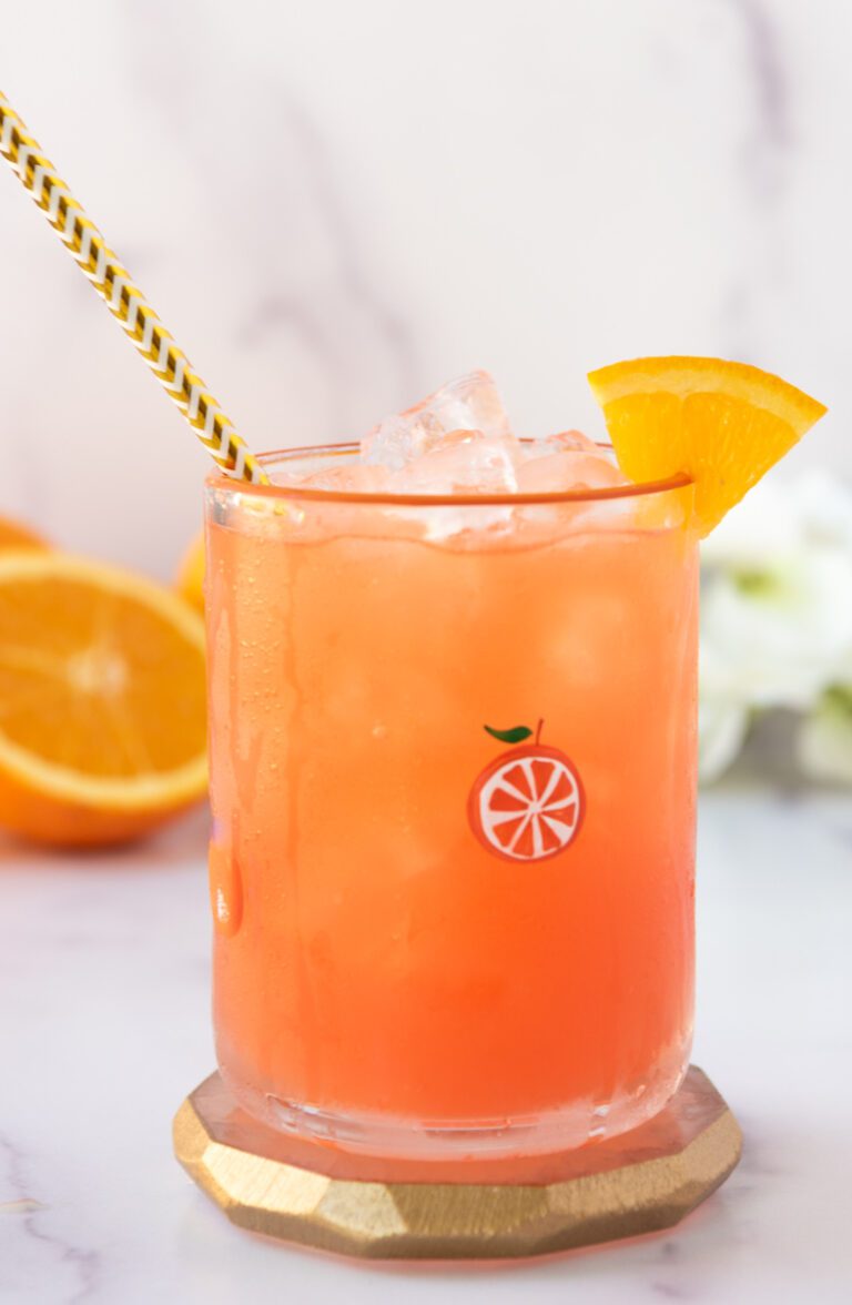 glass of virgin margarita with citrus and gold straw
