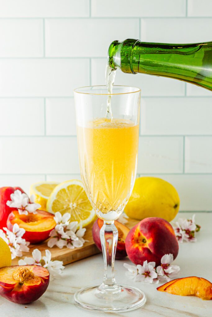 pouring non-alcoholic sparkling wine in champagne glass