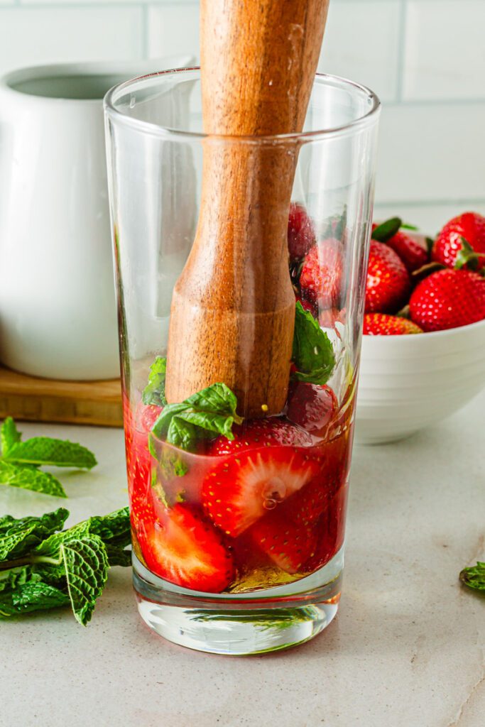muddling strawberry mojioto mocktail